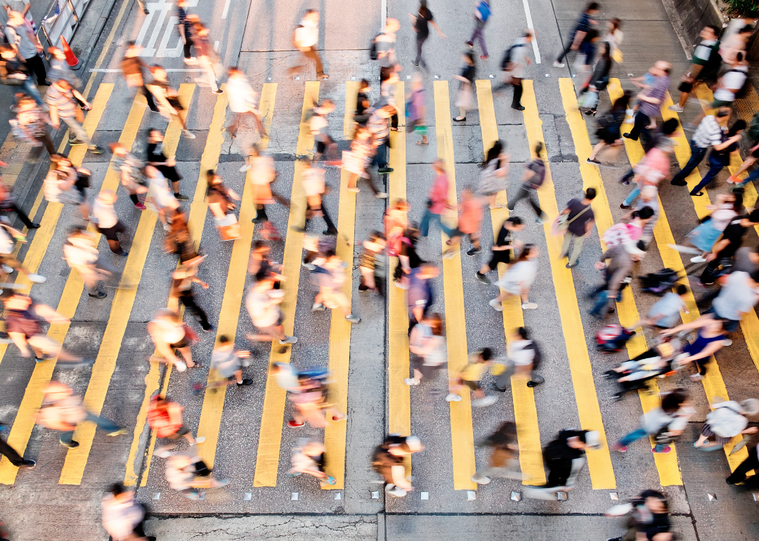 Pedestrians crossing a busy intersection in a city