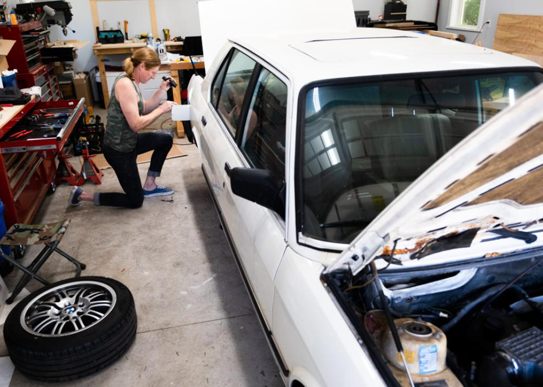 Anna Ray, a transgender woman, performs repairs on her vintage BMW