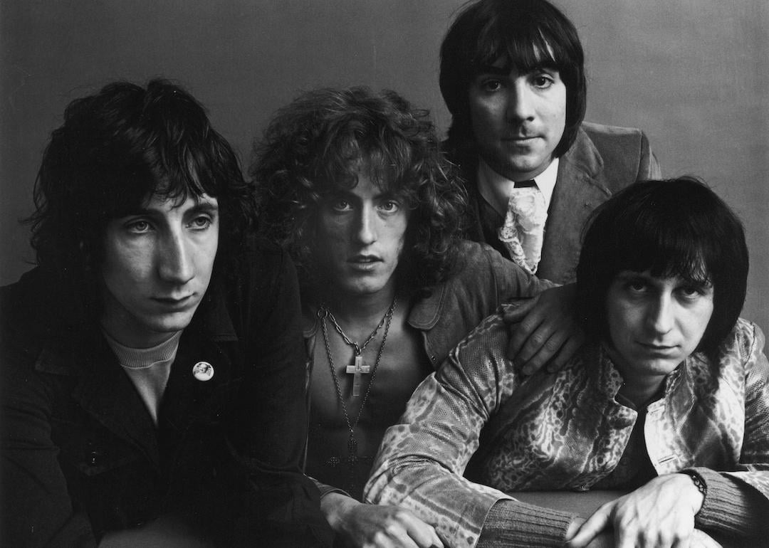 The members of The Who—guitarist Pete Townshend, singer Roger Daltrey, drummer Keith Moon, and bassist John Entwistle—pose around a table for a feature in Vogue magazine in July 1969.