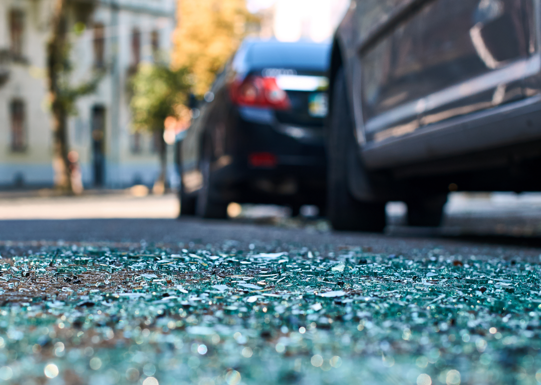 Shards of glass on the street after a car crash in a city.