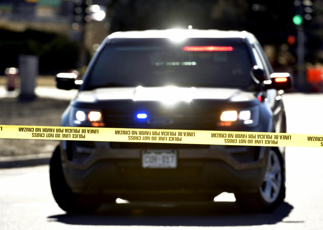 Police officers investigate one of several crime scenes from a shooting spree at 8th Avenue and Zuni Street on December 28, 2021 in Denver, Colorado. A disabled vehicle with a flat tire and shot out window remains in the intersection. A suspect went on a shooting spree on Monday night that spanned two cities, Lakewood and Denver, and claimed the lives of four people and wounded three people including a Lakewood police officer. 