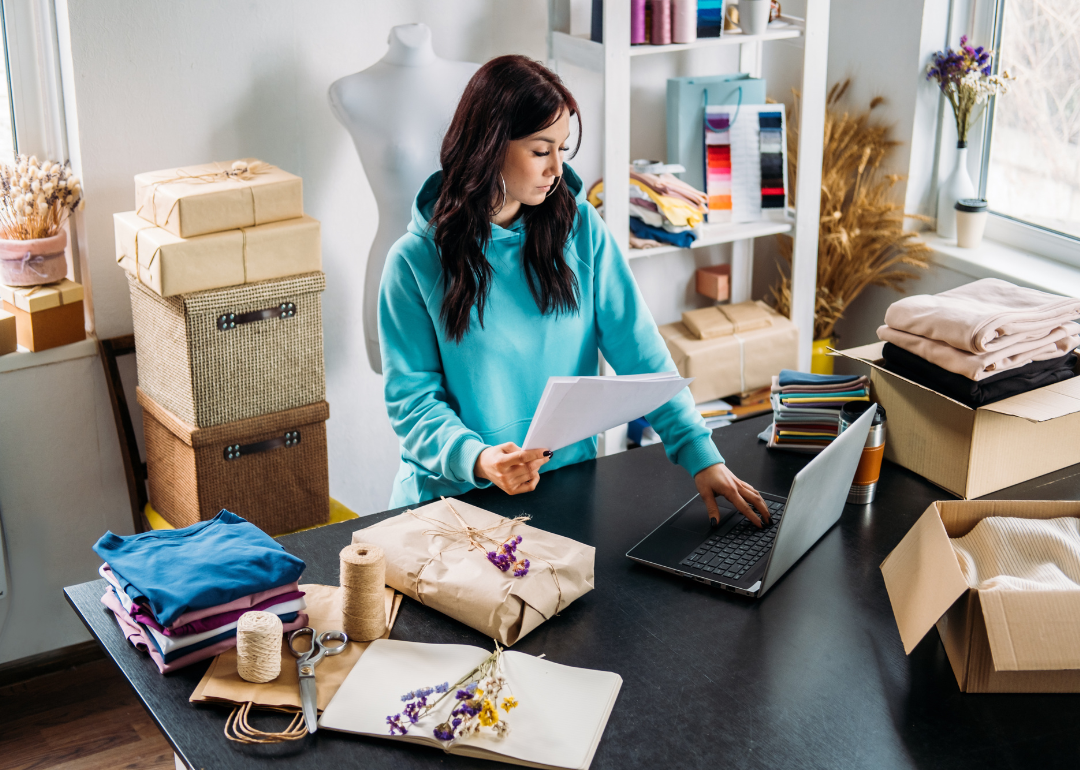 A female small business owner prepares to drop ship products ordered online from her store.