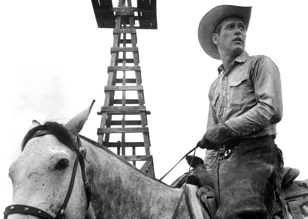 Actor Paul Newman wearing a cowboy hat and riding a horse in the 1963 movie 'Hud.'