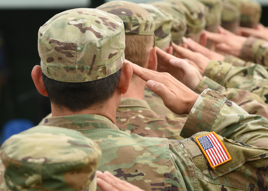 Soldiers of the U.S. Army in uniform give a salute.