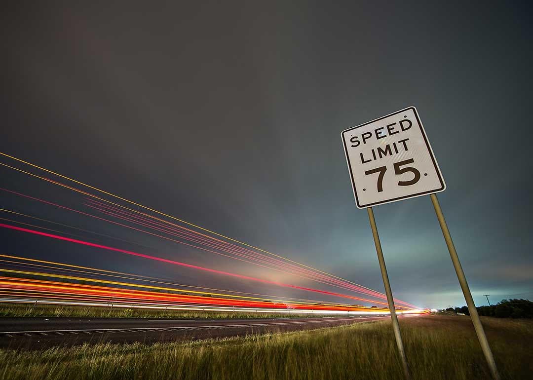 speed limit sign with car headlights motion blur