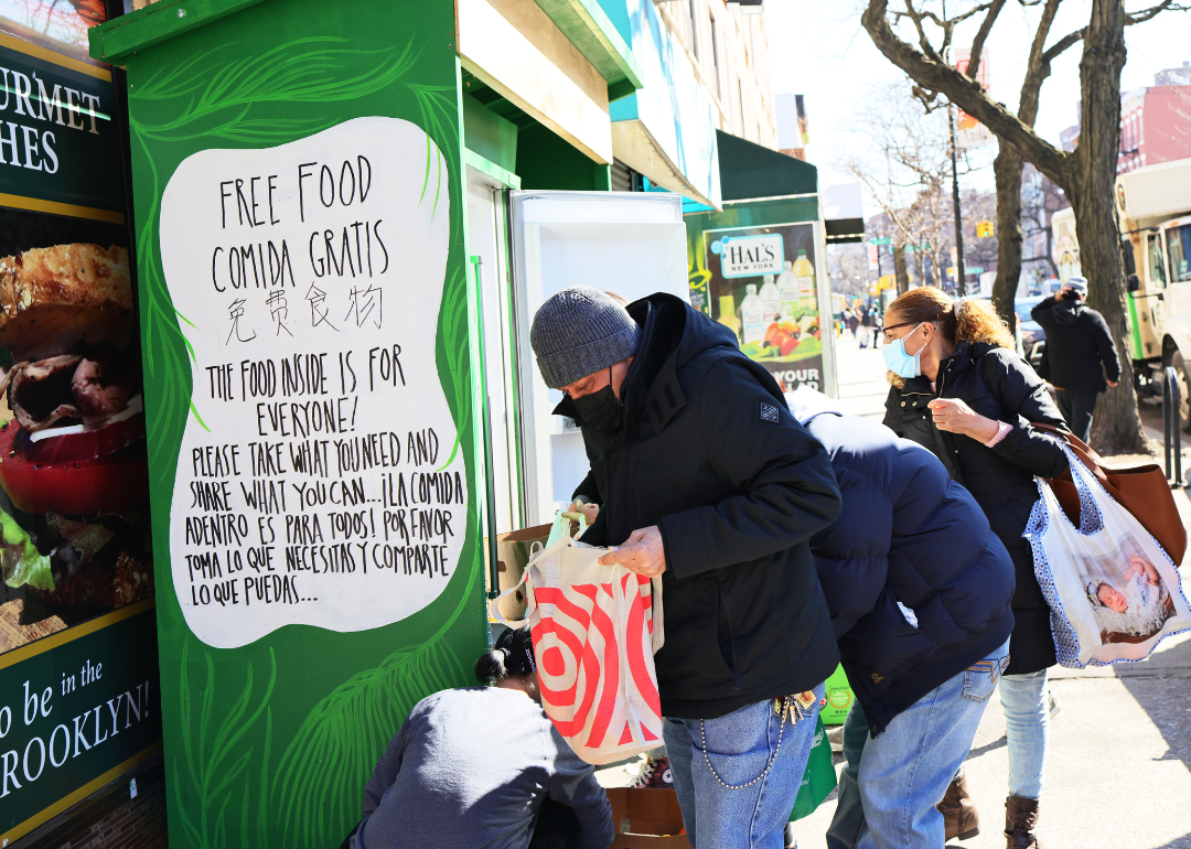 People pick up food from the Clinton Hill-Fort Greene Mutual Aid group's refrigerator on March 03, 2021 in the Fort Greene neighborhood of the Brooklyn borough in New York City. 