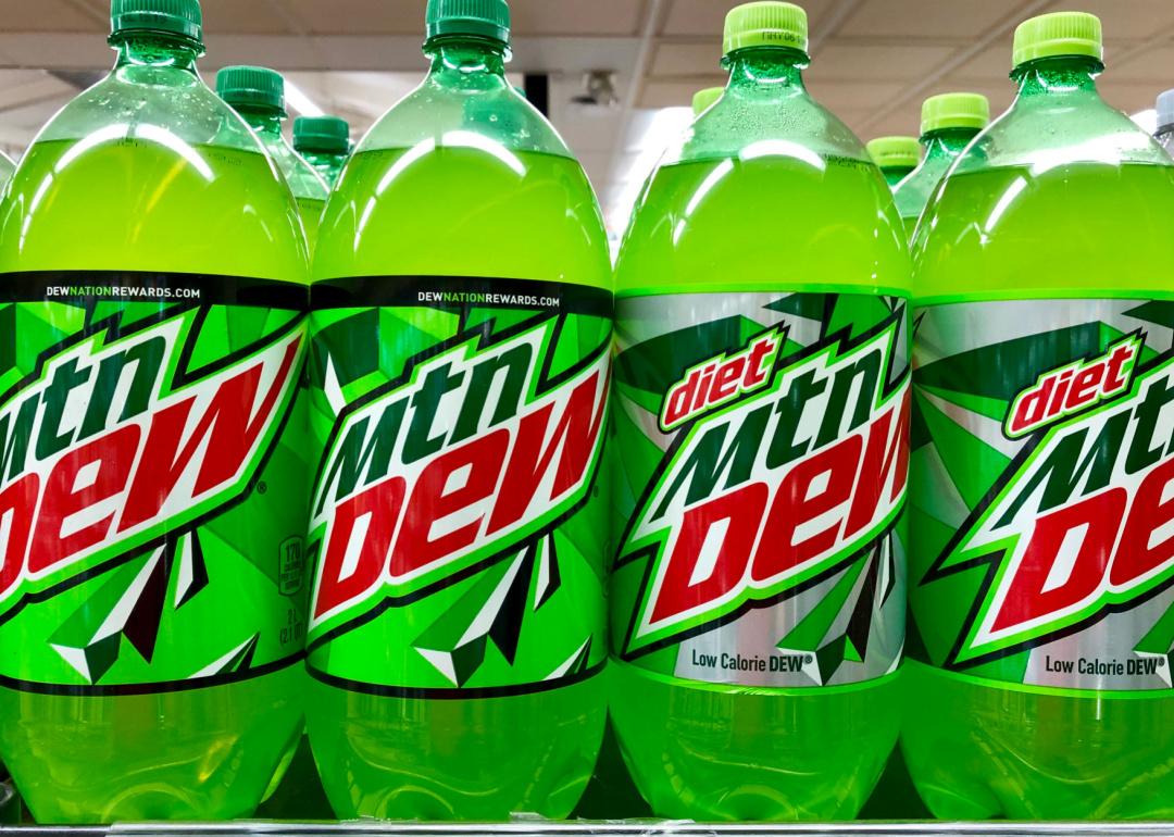 Bottles of Mountain Dew and Diet Mountain Dew on a grocery store shelf.