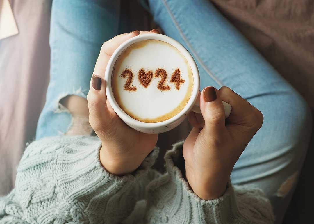 overhead view of a coffee cup with the number "2024" displayed on the foam for the new year