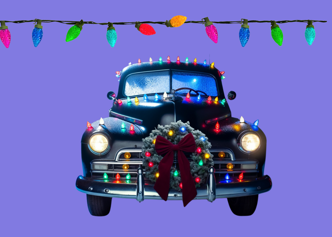 A 1950s era sedan decorated with Christmas lights and wreaths