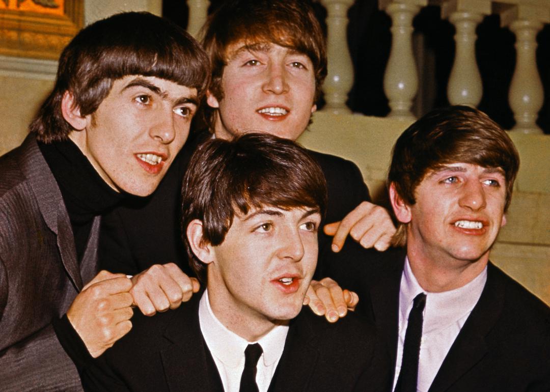 The Beatles smiling together: from left to right: George Harrison, John Lennon, Paul McCartney, and Ringo Starr.