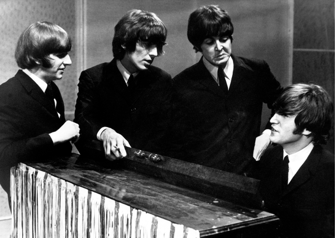  During the recording of a televised program in Manchester, the four members of the British pop group, The Beatles, talking next to the piano, 1962-1965. 