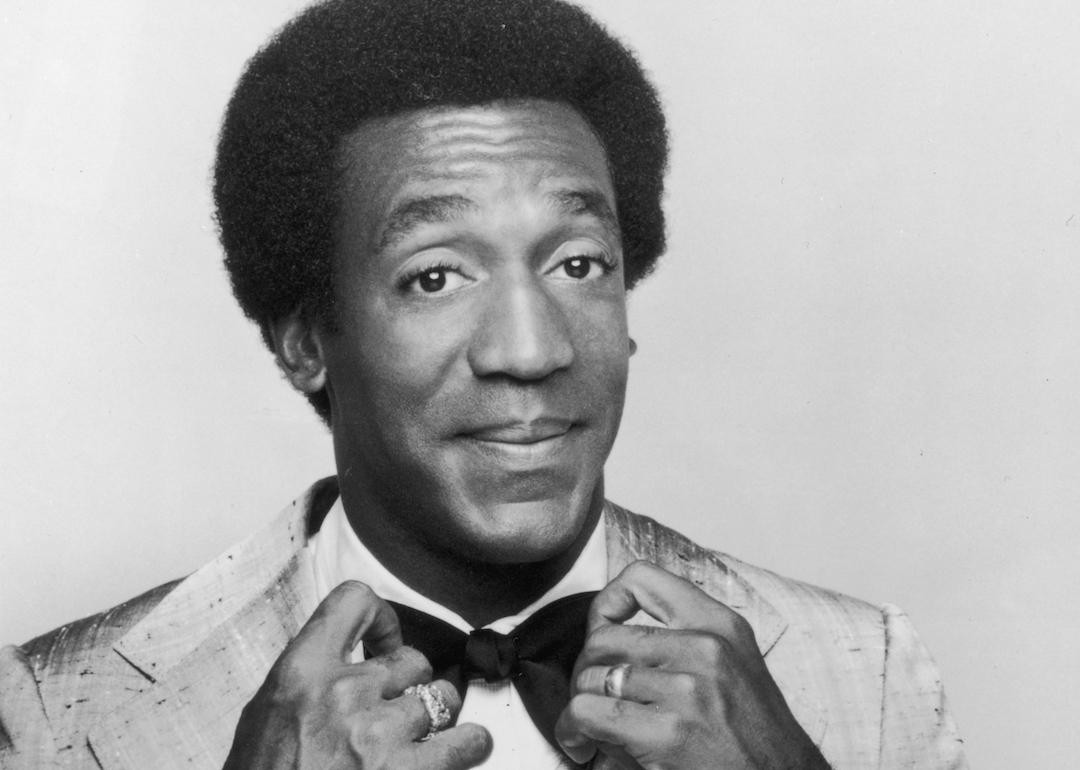 Promotional studio portrait of actor and comedian Bill Cosby adjusting his bow tie from his 1969 television series 'The Bill Cosby Show'.