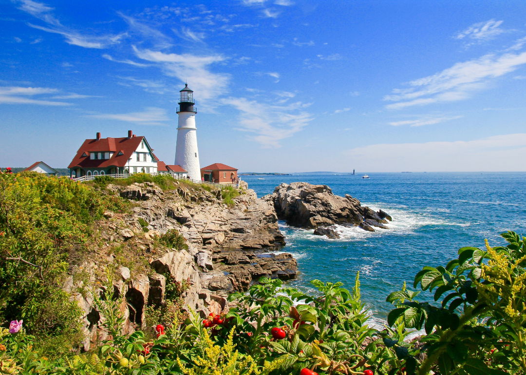 Lighthouse on a cliff overlooking the ocean in Cape Elizabeth, Maine