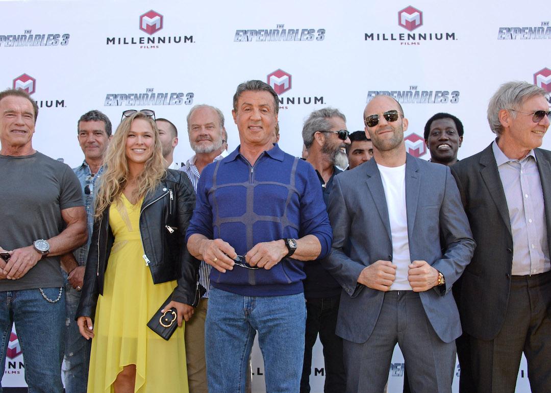 Cast members of the movie 'The Expendables 3':  Arnold Schwarzenegger, Antonio Banderas, Ronda Rousey, Glen Powell, Kelsey Grammer, Sylvester Stallone, Mel Gibson, Victor Ortiz, Jason Statham, Wesley Snipes, and Harrison Ford.