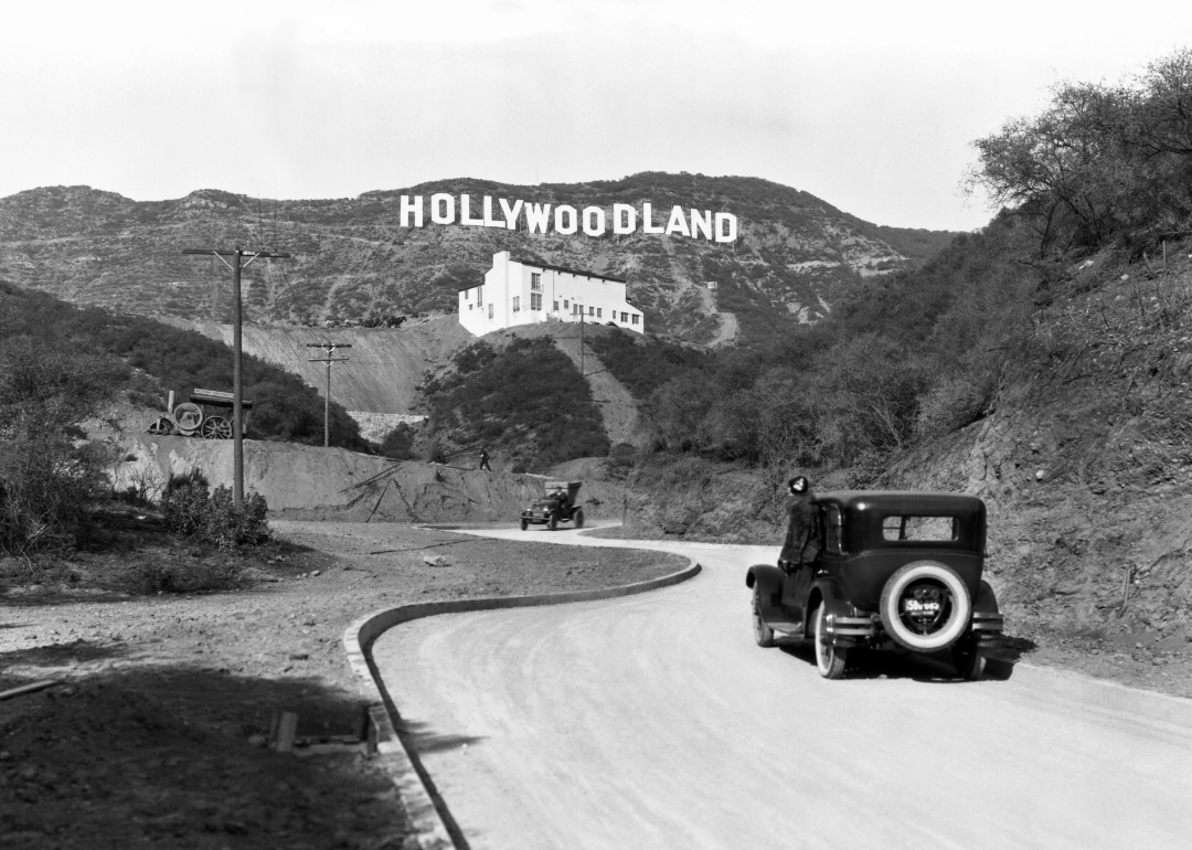 A sign advertises the opening of the Hollywoodland housing development in the hills on Mulholland Drive overlooking Los Angeles, Hollywood, Los Angeles, California, circa 1924.