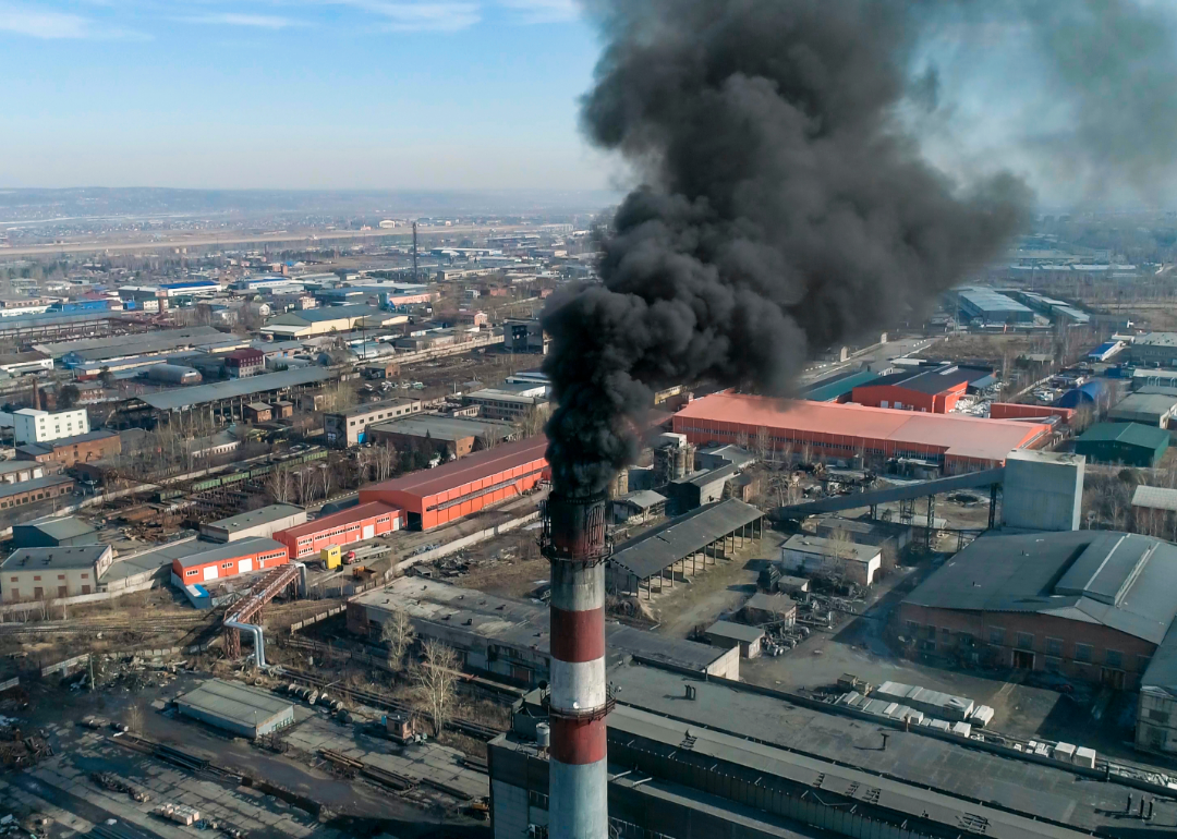 dark smoke rises out of smokestack of coal-fired plant 