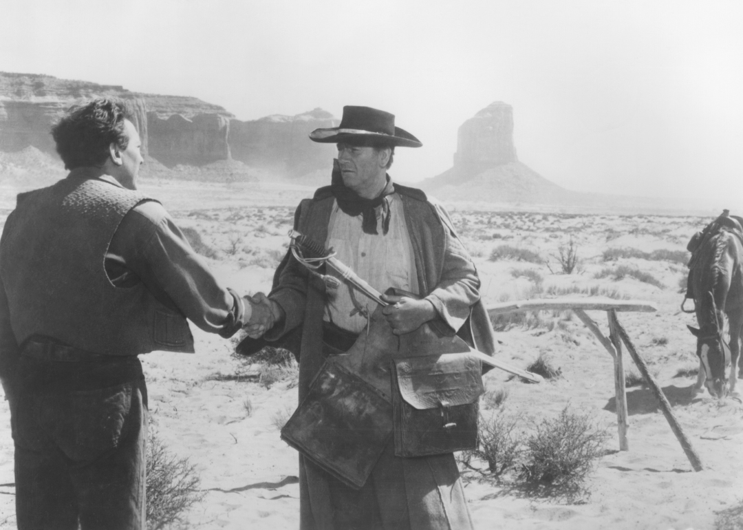 John Wayne as Ethan Edwards greets his brother Aaron, played by Walter Coy in front of Monument Valley , Utah, in a scene from the 1956 John Ford directed western 'The Searchers'.