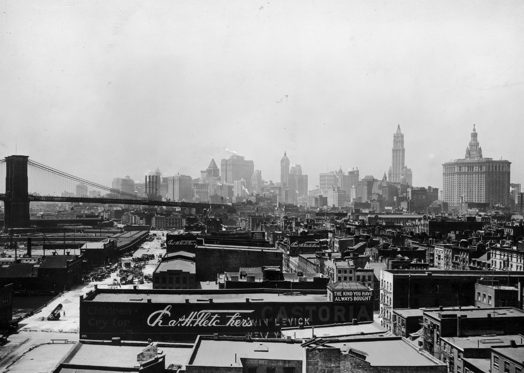 View of the buildings at South Street Seaport and the Brooklyn Bridge, with the office buildings of Lower Manhattan in the background.
