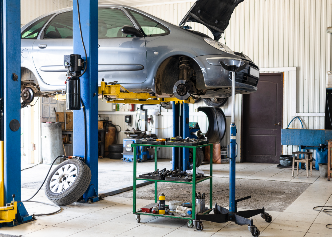 car in auto shop on hydraulic lift