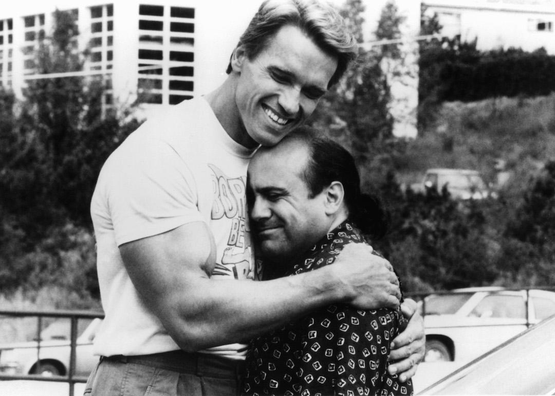 Arnold Schwarzenegger embracing Danny DeVito in a scene from the '80s movie 'Twins.'