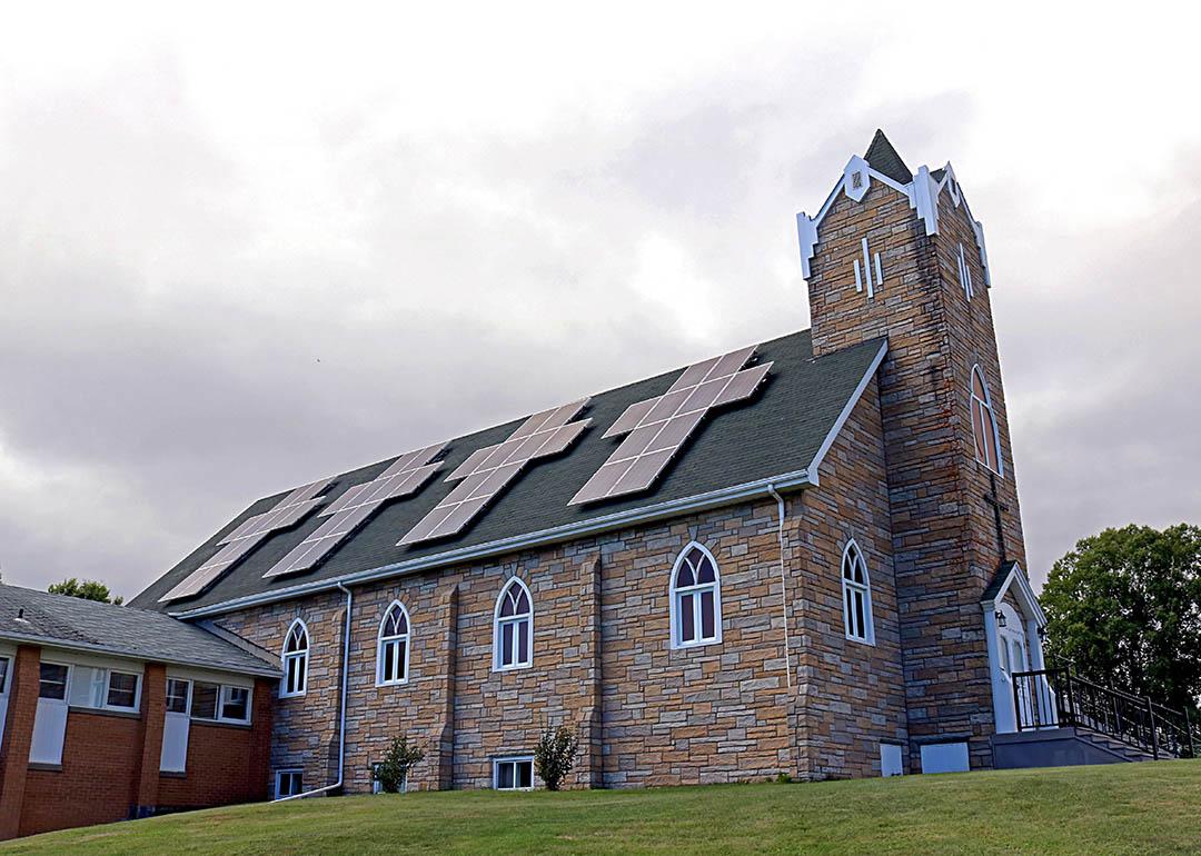 church with solar panels on roof in shape of cross