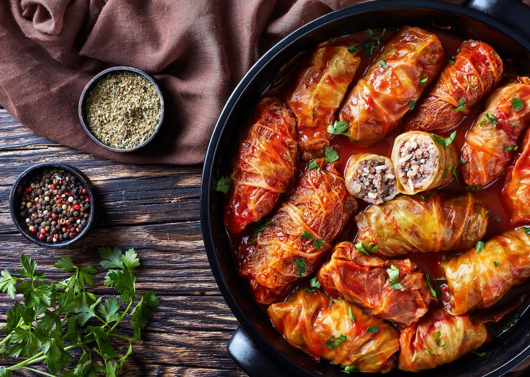 Overhead view of Hungarian cabbage rolls stuffed with ground beef and rice with a tangy tomato sauce in a slow cooker.