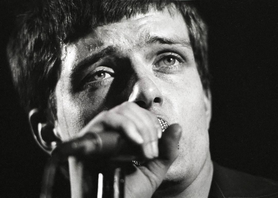 Singer Ian Curtis of Joy Division performing live onstage in 1980.