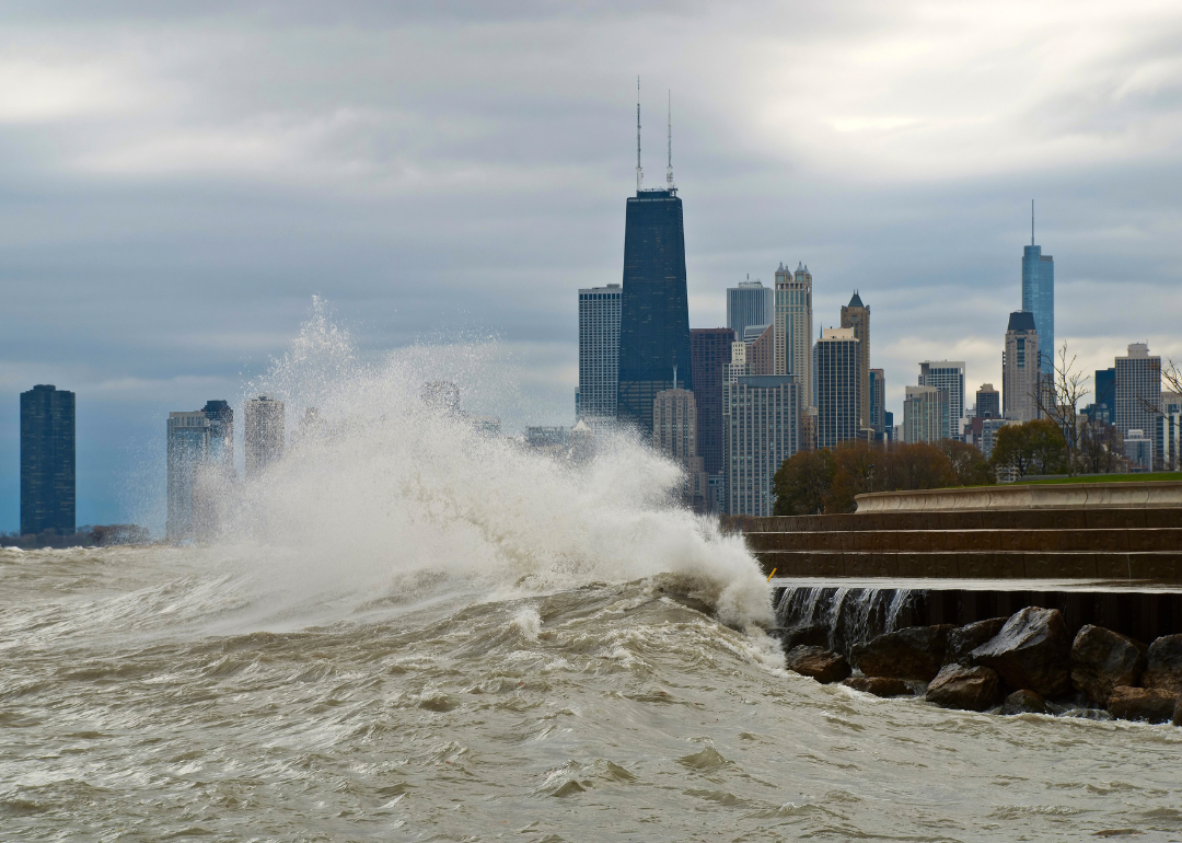 Huge waves on Lake Michigan crash against the shores of Chicago, skyline in the background