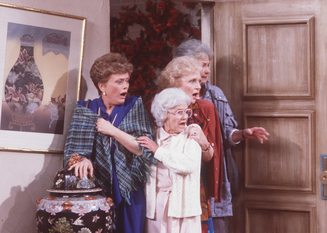 A scene from 'Golden Girls': Actors Roe McClanahan, Estelle Getty, Betty White, and Beatrice Arthur standing at a doorway looking shocked.