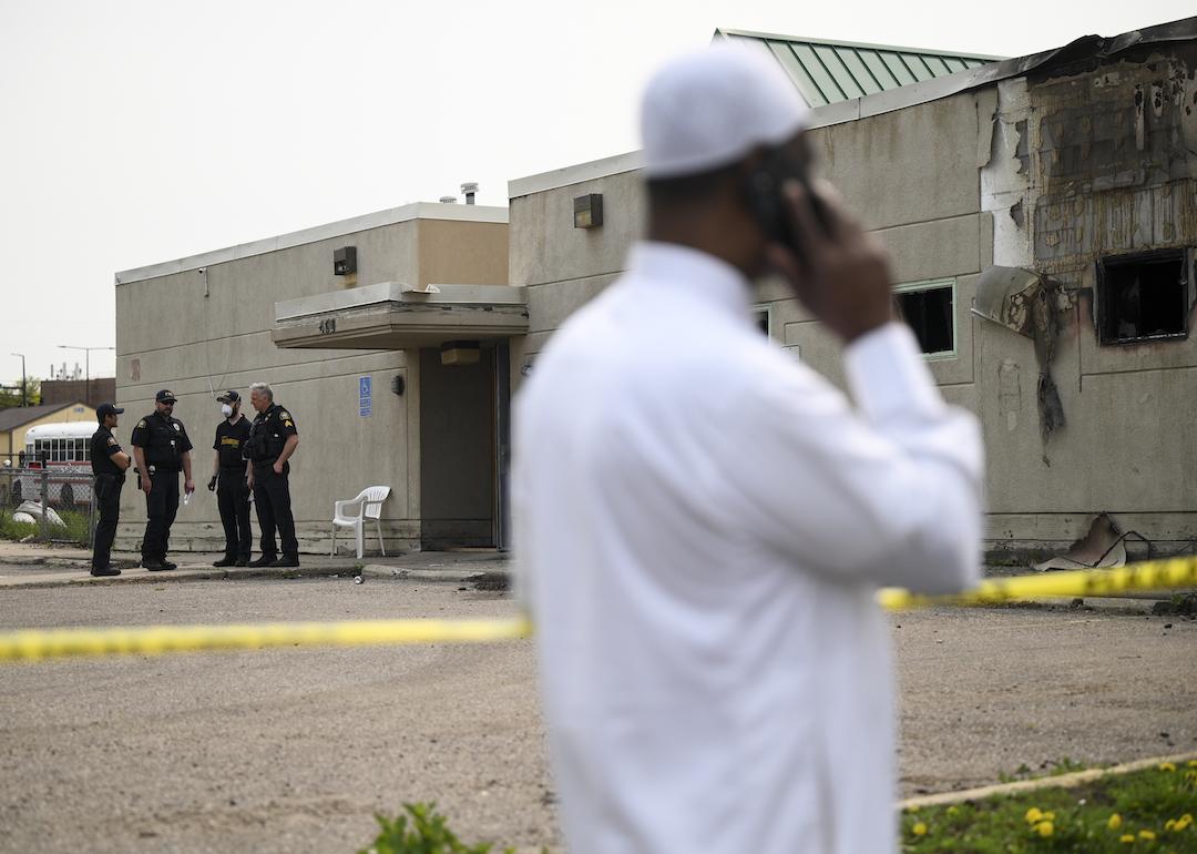 Police and community members gather outside the burned-out Tawhid Islamic Center on May 17, 2023 in St. Paul, Minnesota.