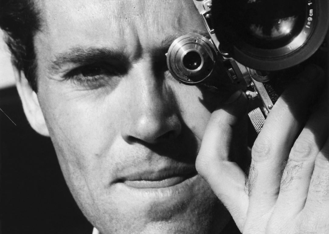 Henry Fonda poses with his camera