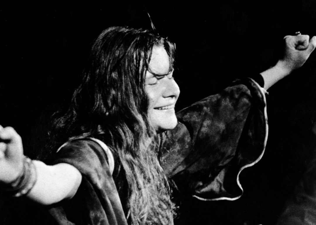 American singer Janis Joplin (1943 - 1970) closes her eyes and outstretches her arms during a performance, late 1960s. 