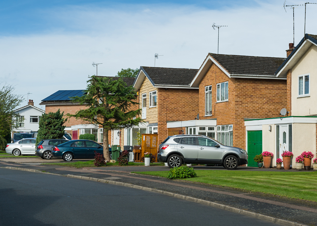 Suburban residential street with cars parked outside houses