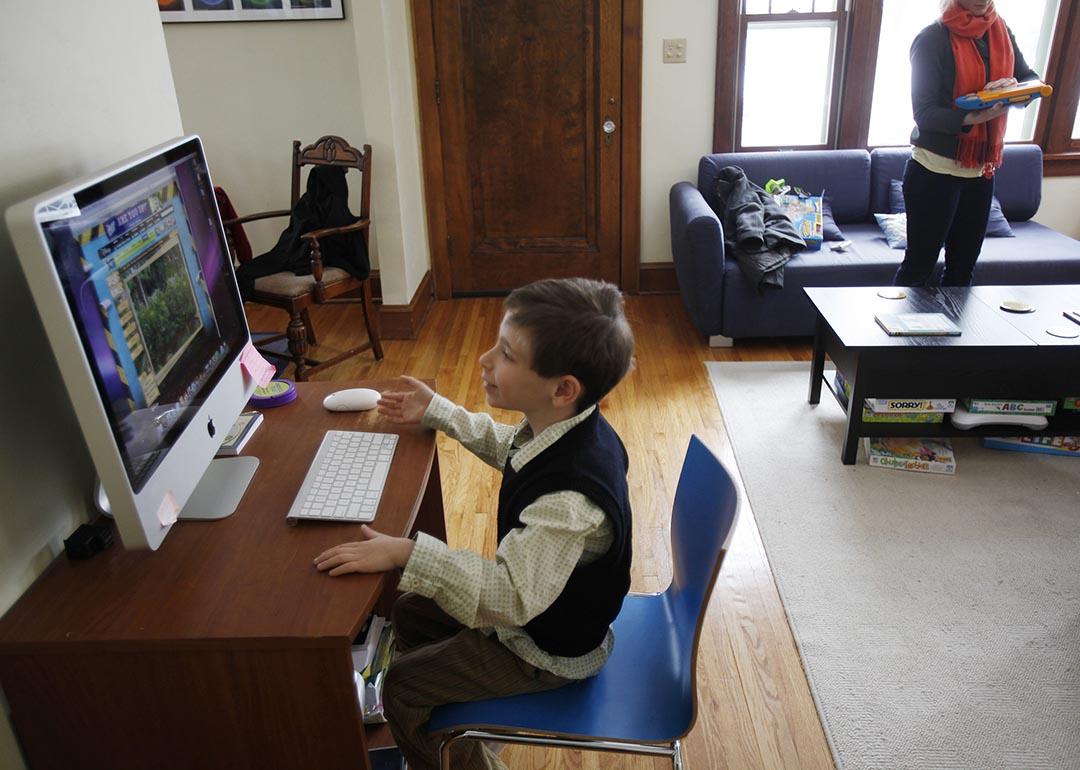 a young boy takes some time away from ABA therapy to play a game on family computer