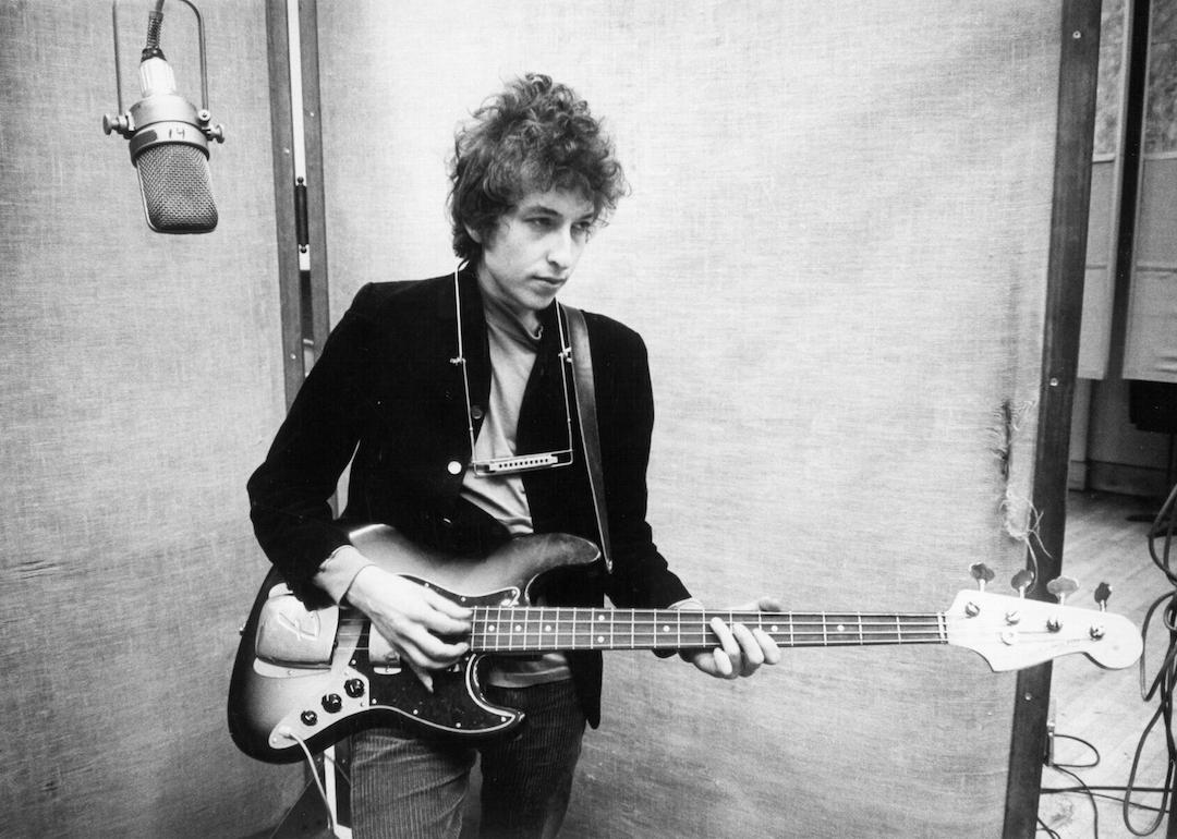 Bob Dylan plays a Fender Jazz bass with the harmonica around his neck while recording his album 'Bringing It All Back Home' on January 13-15, 1965 in Columbia's Studio A in New York City, New York.