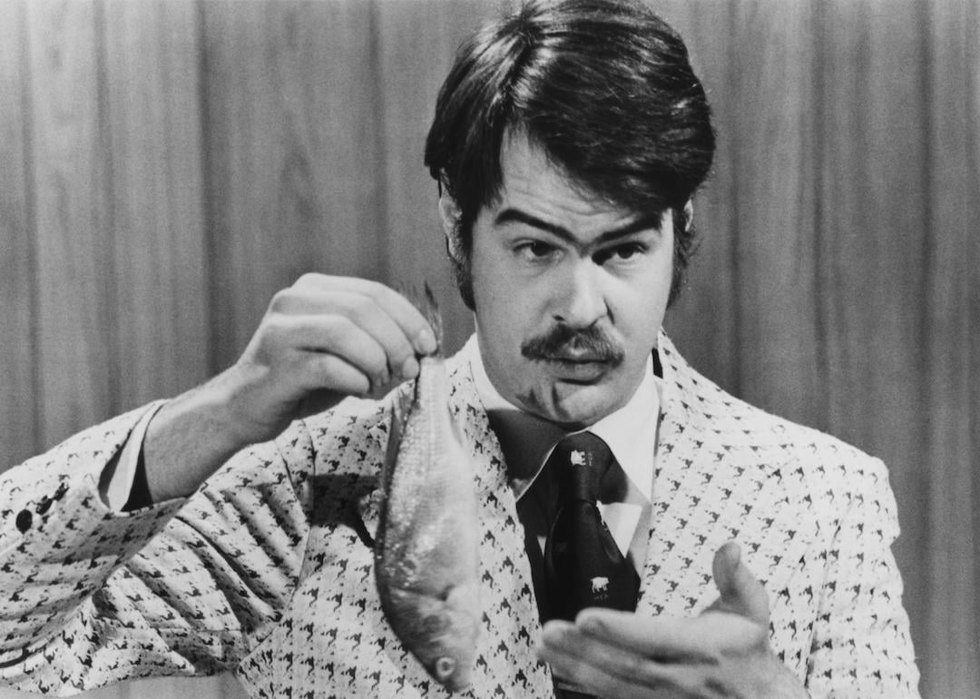 Canadian-American comedian Dan Aykroyd prepares to demonstrate the 'Super Bass-O-Matic' on a sketch from the TV comedy show 'Saturday Night Live', 1976.