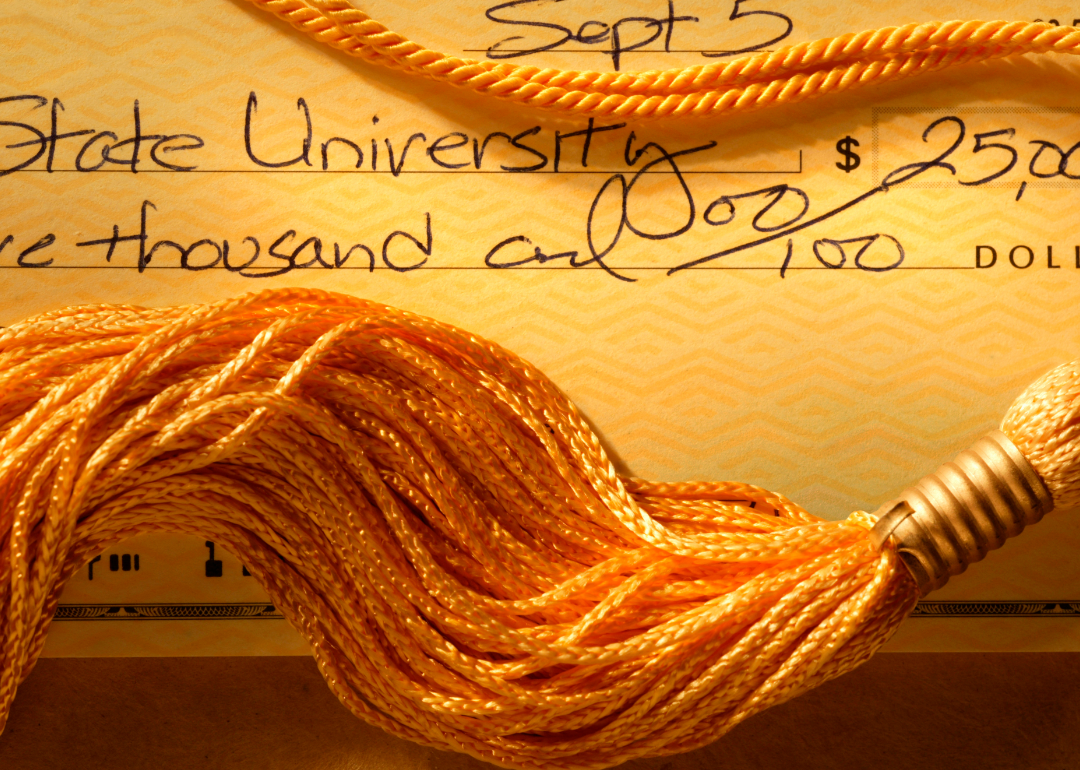 A close look at a state university-issued check worth $25,000 and a tassel covering it.