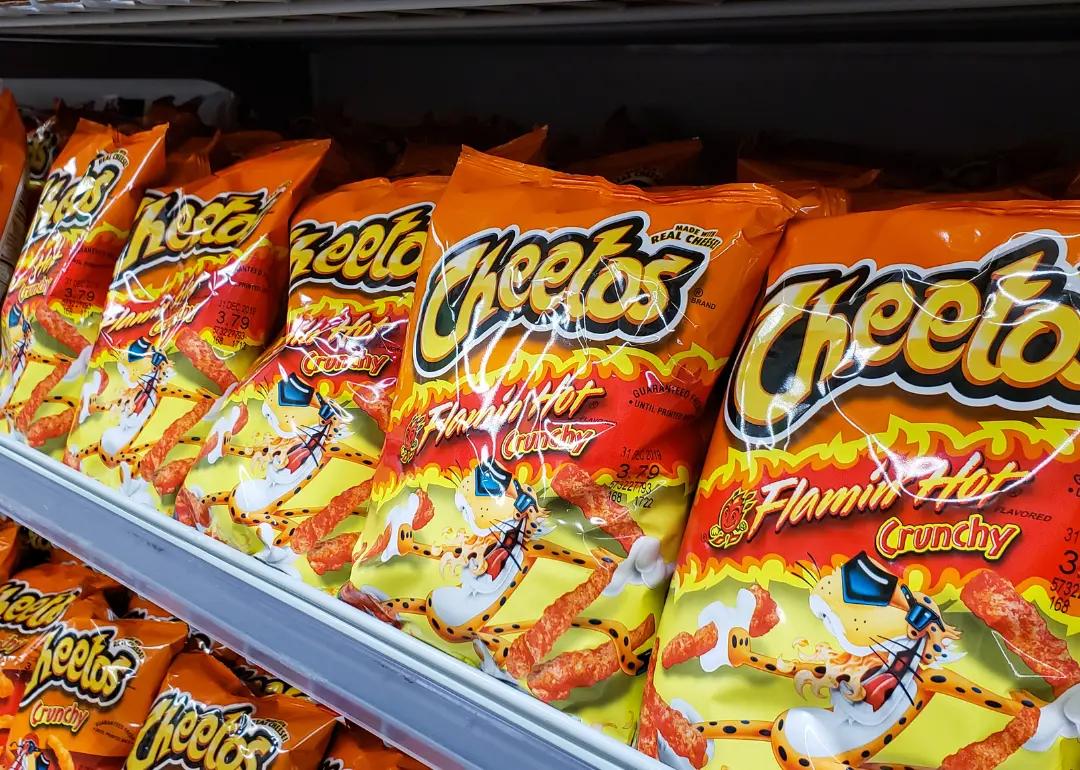 Several bags of Flamin' Hot Cheetos at the grocery store.