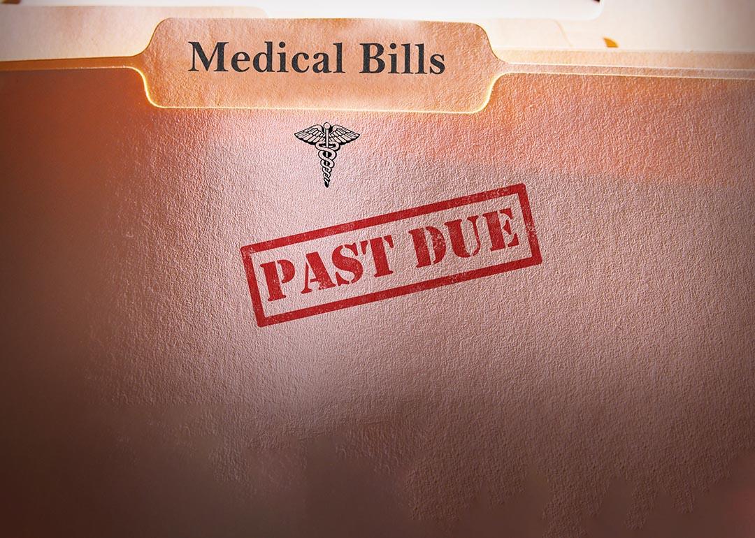 File folders of medical bills stamped with past due label