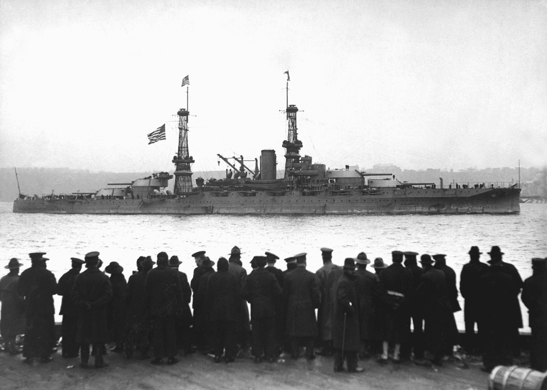 View of crowds gathered at the 96th Street Pier to watch the USS Arizona leading the fleet in a naval review for Secretary of the Navy Josephus Daniels, upon the fleet's arrival home at the end of the First World War, NY December 1918.