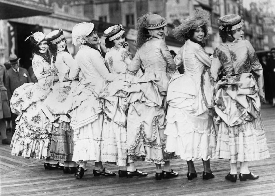 A group of women dressed in bustle gowns on the boardwalk in the 1890s.