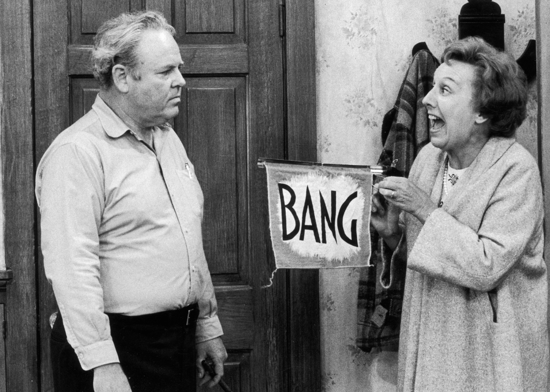 American actor Jean Stapleton (right) points a toy gun with a flag that reads, 'Bang,' at American actor Carroll O'Connor (1924 - 2001), in a still from the season premiere of the television series 'All in the Family'. 