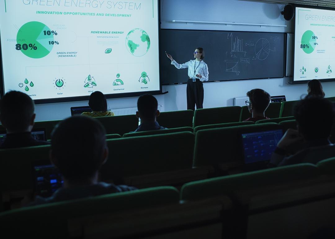 A professor in front of a class presenting about the green energy sytem.