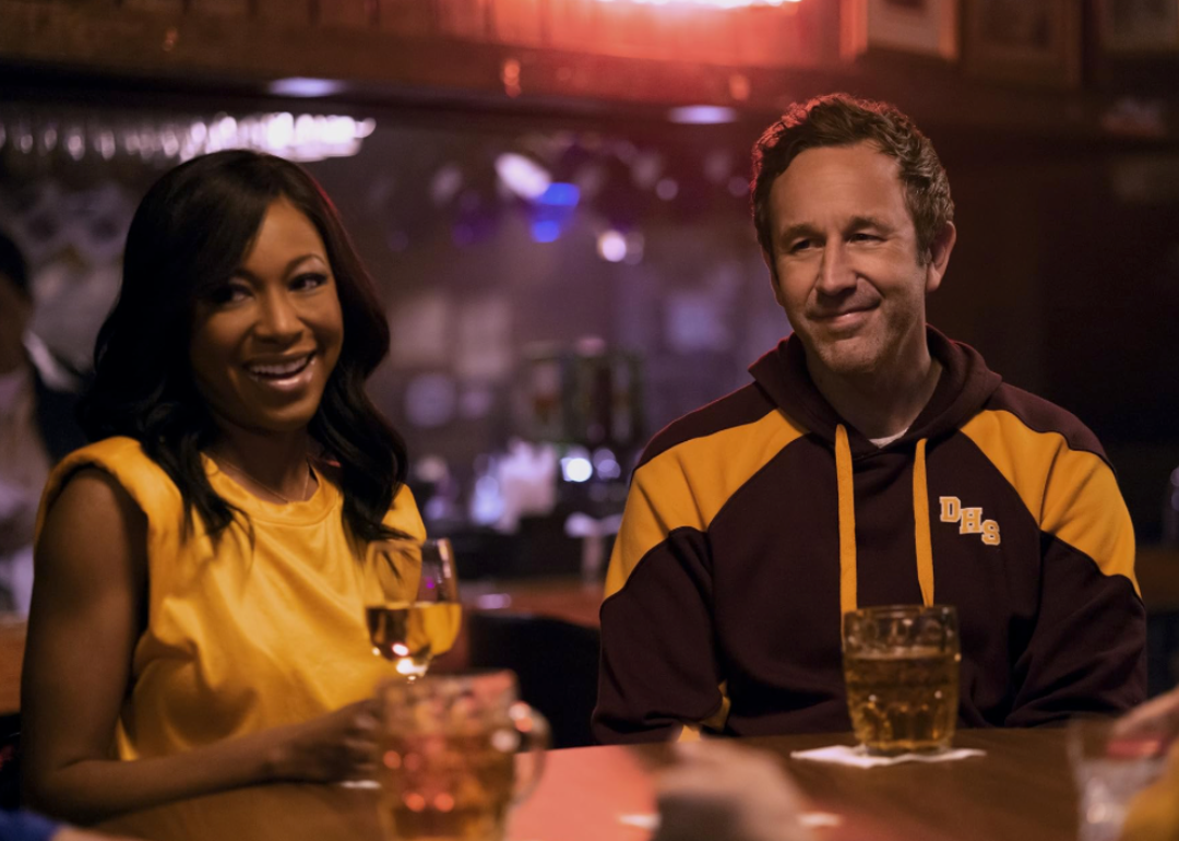 Chris O'Dowd and Gabrielle Dennis sitting at a bar table in a scene from 'The Big Door Prize' (2023)
