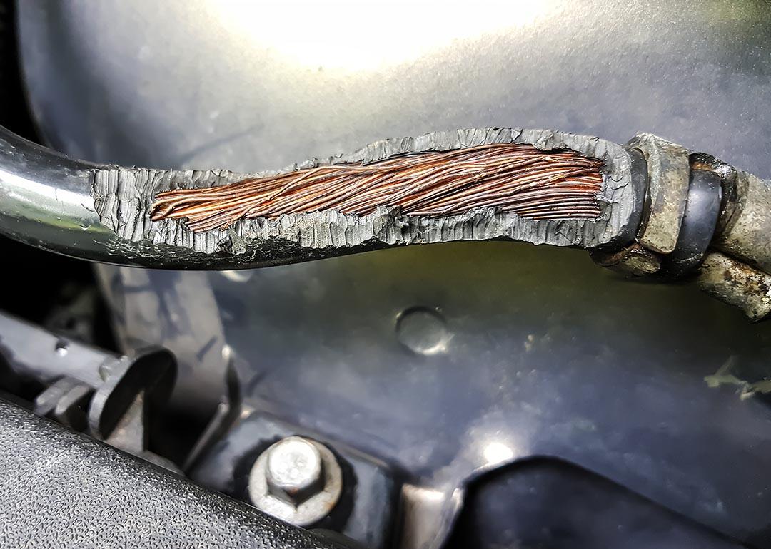 Close up of rubber over wiring in car worn away by rat chewing.