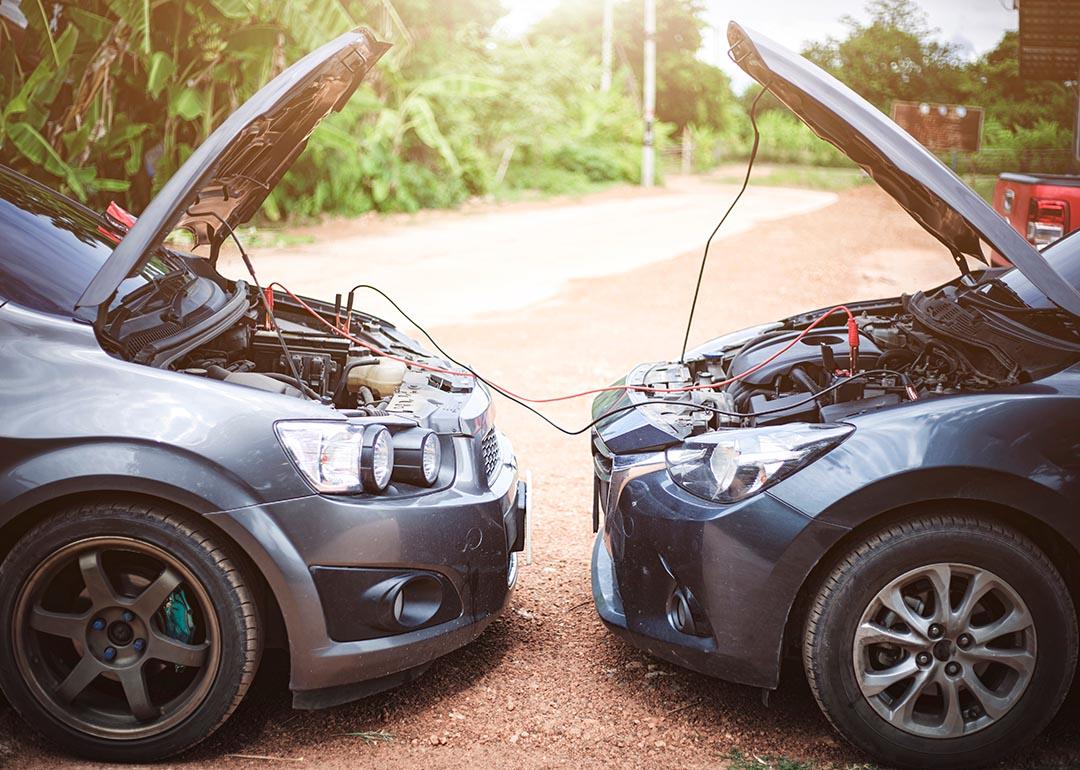 Two cars on a roadside showing a jump-start.