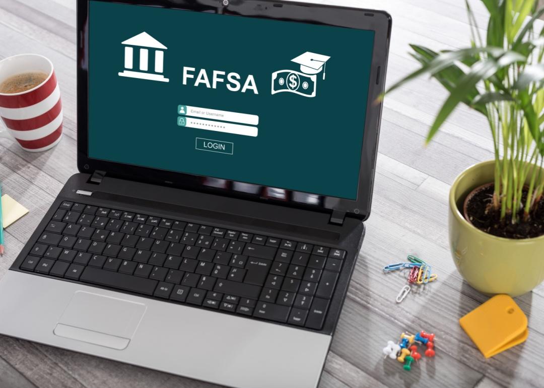 A laptop on a desk with FAFSA concept on the screen.