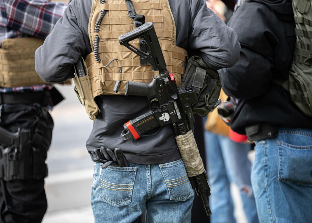 People photographed form behind with guns on their back in Carson City, Nevada.