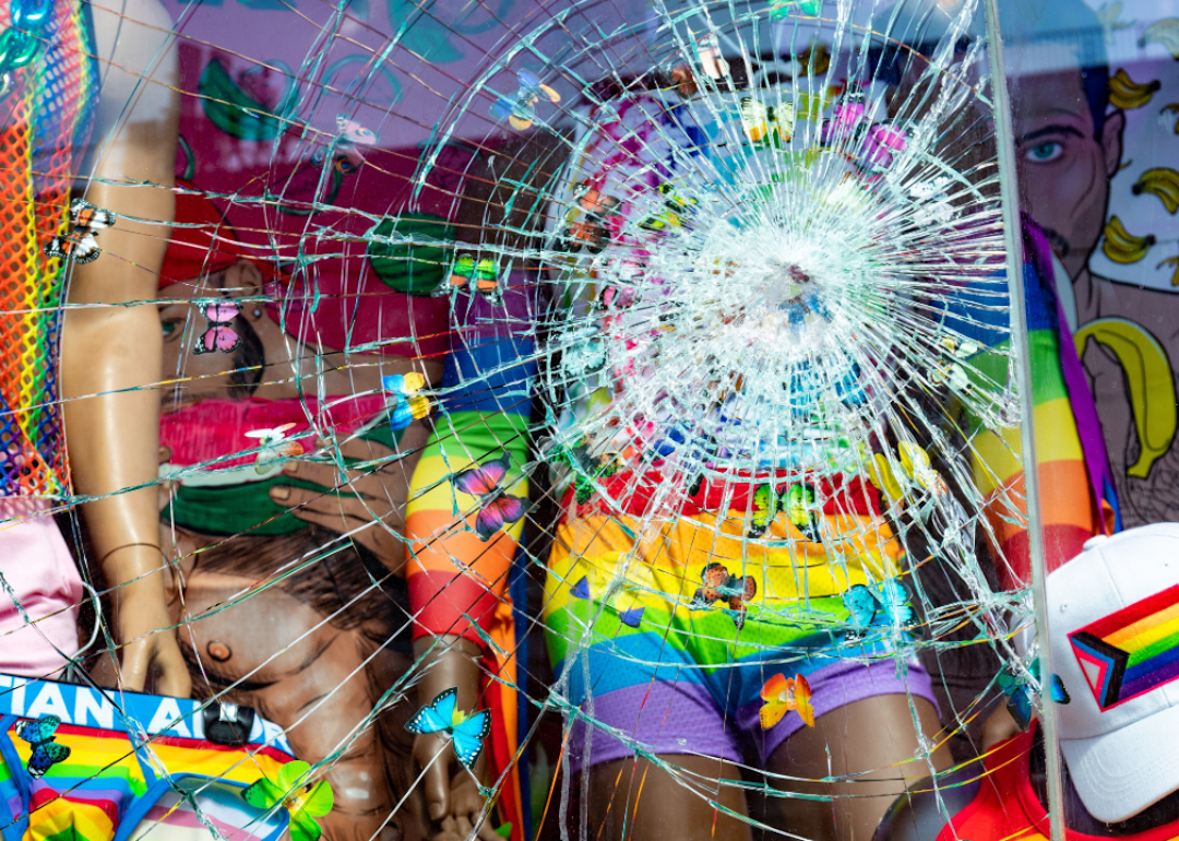 Broken window on LGBTQ fashion boutique storefront in New York City from vandalism.