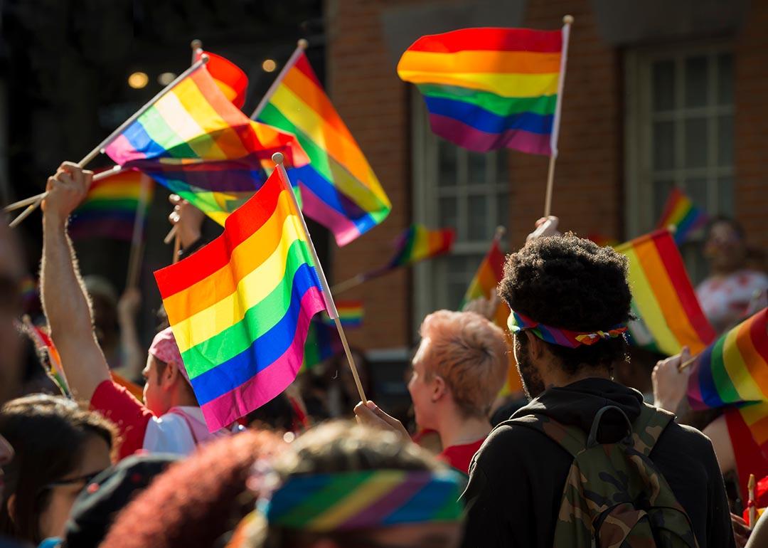 Supporters wave rainbow flags and signs at the annual Pride Parade as it passes through Greenwich Village in New York City.